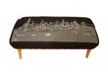 Rectangular ottoman upholstered in gray wool with a black fabric featuring a white and red New York City skyline and river scene.