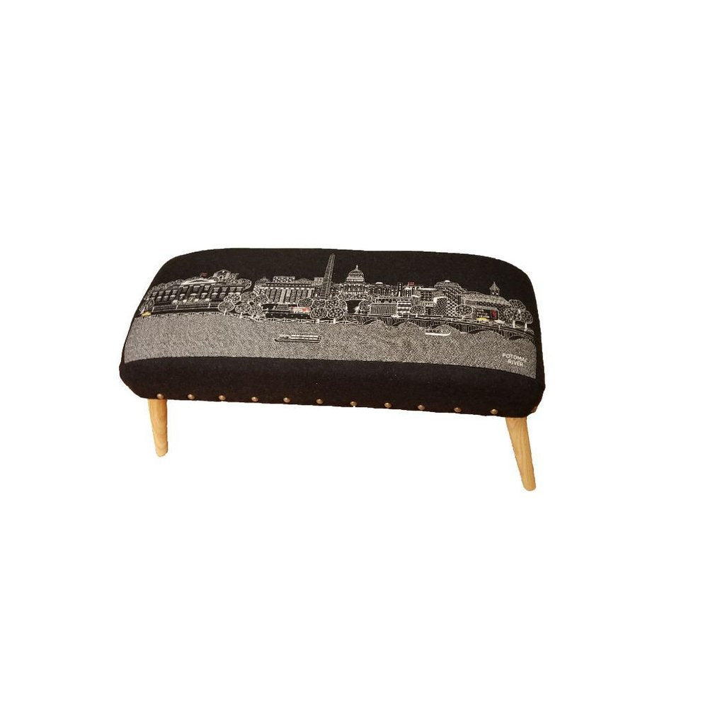 Gray wool ottoman with a black fabric top featuring a white line drawing of the Washington D.C. skyline and Potomac River.