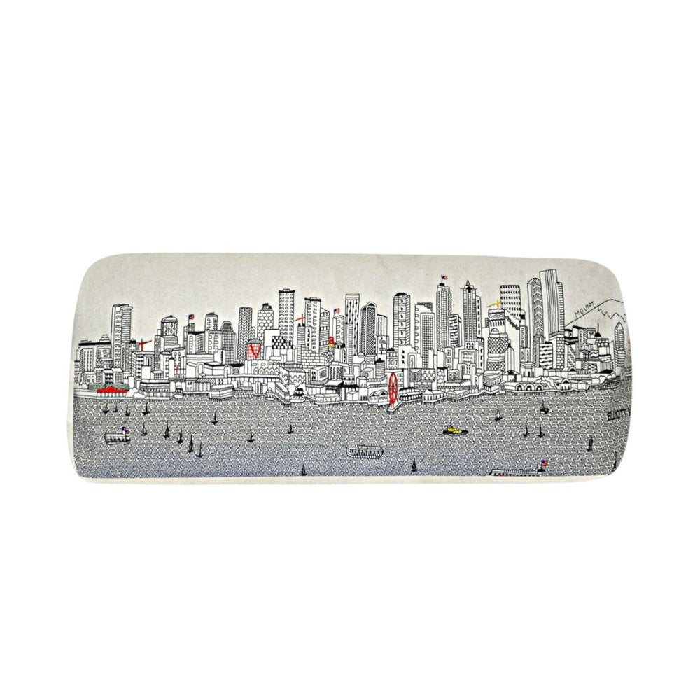 Cream wool ottoman with a black and white sketch of a city skyline and boats on water.