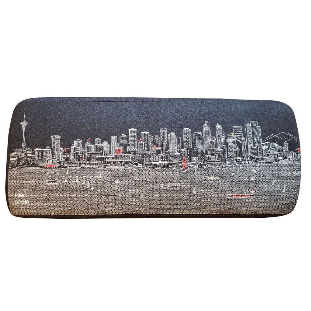 Gray wool ottoman with a detailed white and red skyline of Seattle and Puget Sound printed on it.