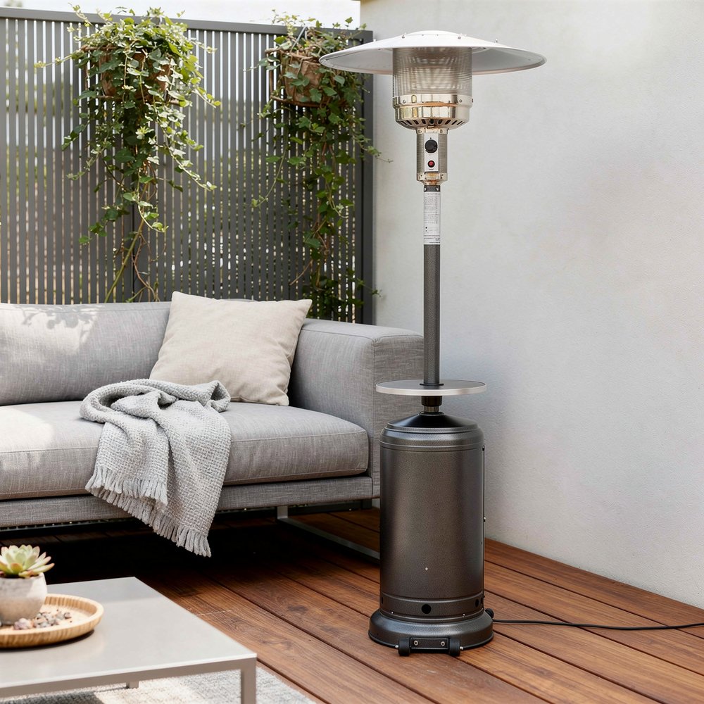48000 BTU Silver Steel Propane Cylindrical Pole Standing Patio Heater - SKU 480568 styled in a furnished interior with an off-white wall on a wood floor.
