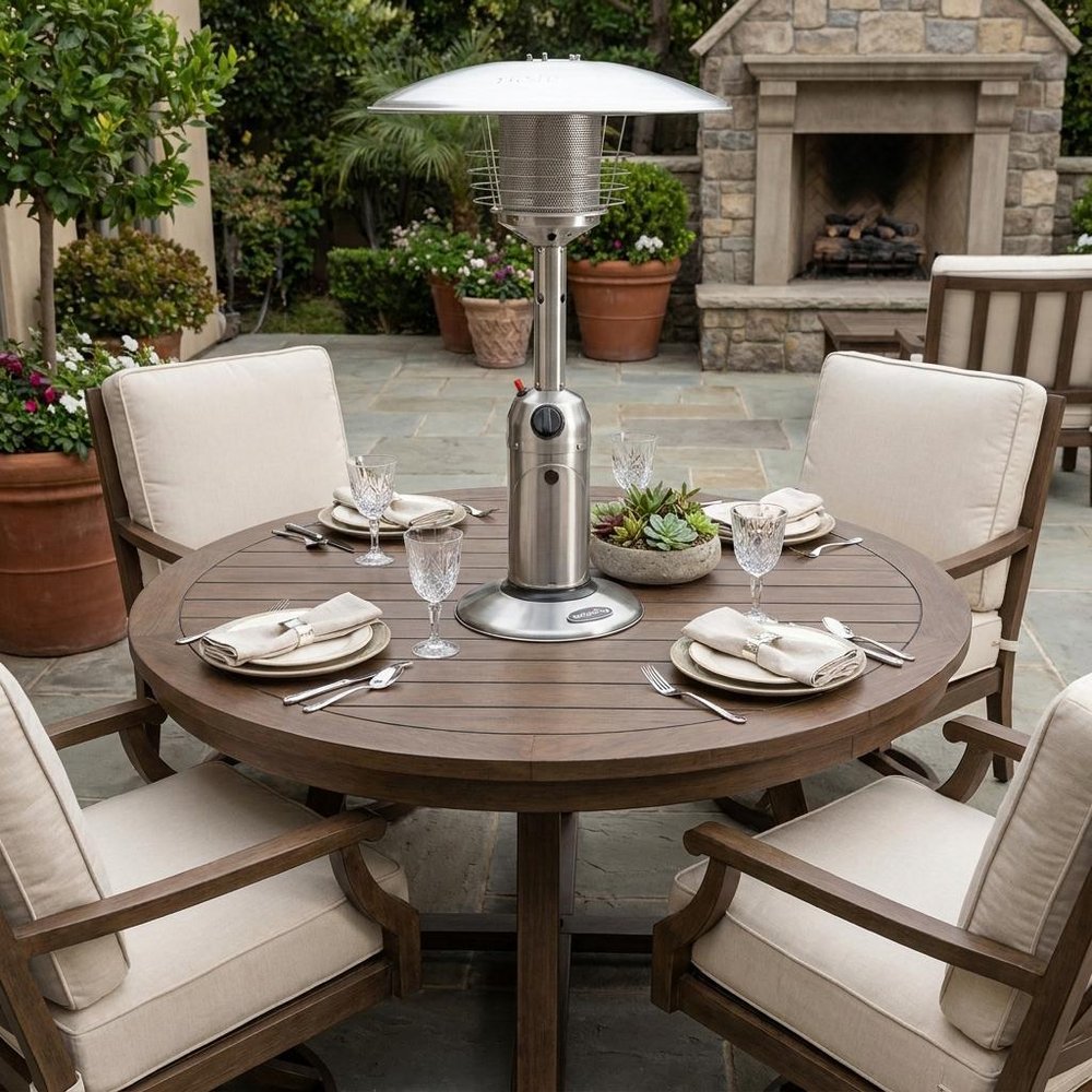 11000 BTU Silver Steel Propane Cylindrical Pole Tabletop Patio Heater - SKU 480579 styled in a furnished interior with a green wall on a dark wood floor.