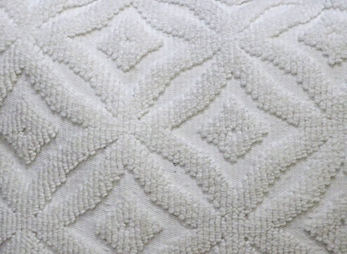 White textured ogee pattern pillow, made of fabric, suitable for indoor or outdoor use.