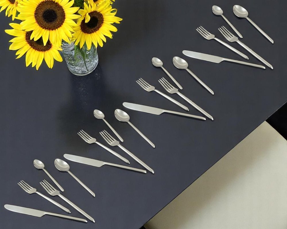 Glossy Silver Stainless Steel Twenty Piece Hand Forged Flatware Set in a home interior