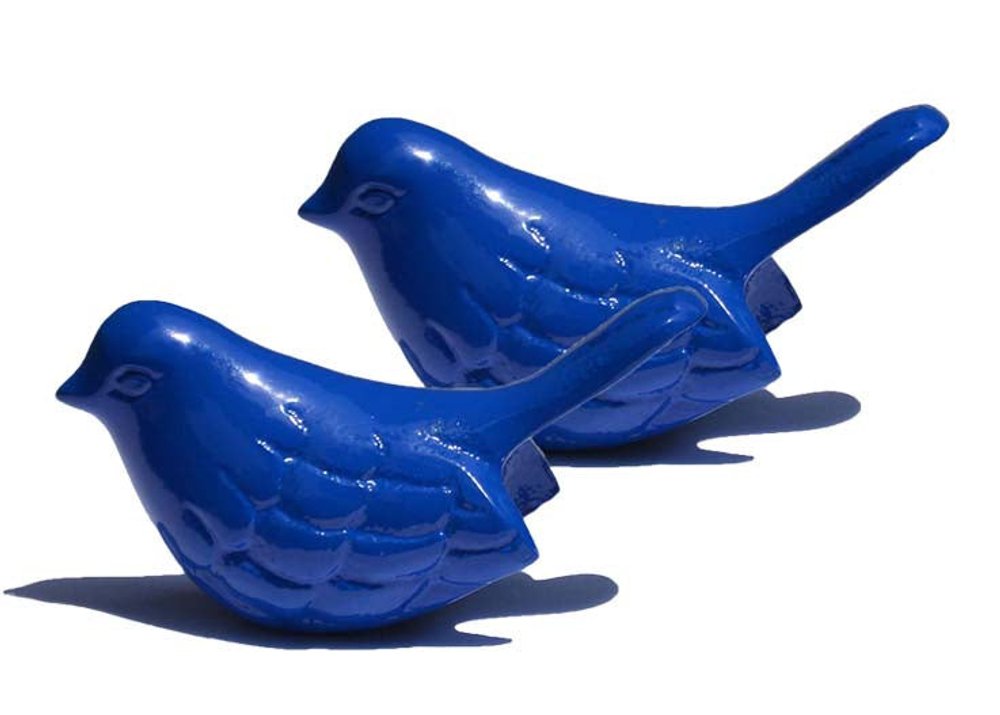 Two shiny blue metal bird sculptures are shown against a white background.