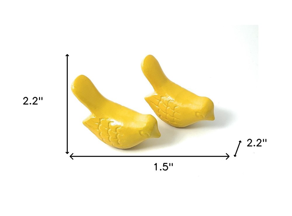 Set of Two Yellow Metal Bird Tabletop Sculpture on a white background