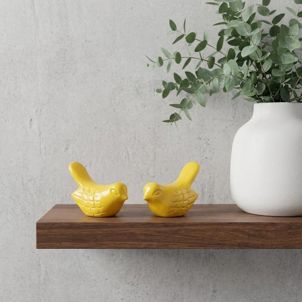 Set of Two Yellow Metal Bird Tabletop Sculpture in a home interior