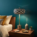28" Silver Metal Table Lamp With Geometric Laser Cut Metal Shade shown outdoors on an outdoor setting.