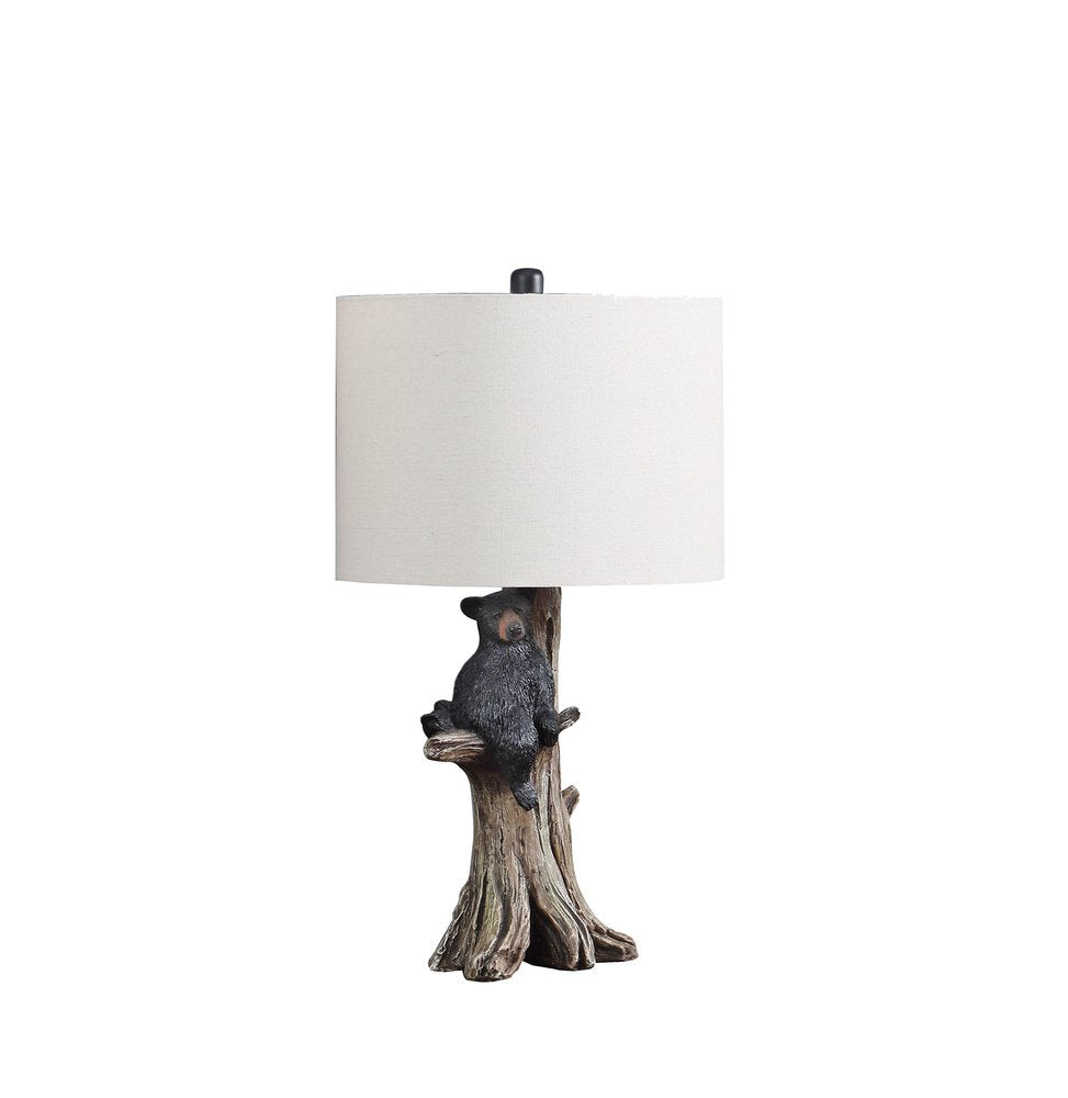 25" Black Bear in a Tree Table Lamp With Beige Shade. Table lamp isolated on a plain white background, showing its beige color.