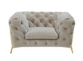 Beige velvet tufted lounge chair with gold metal legs on a white background.