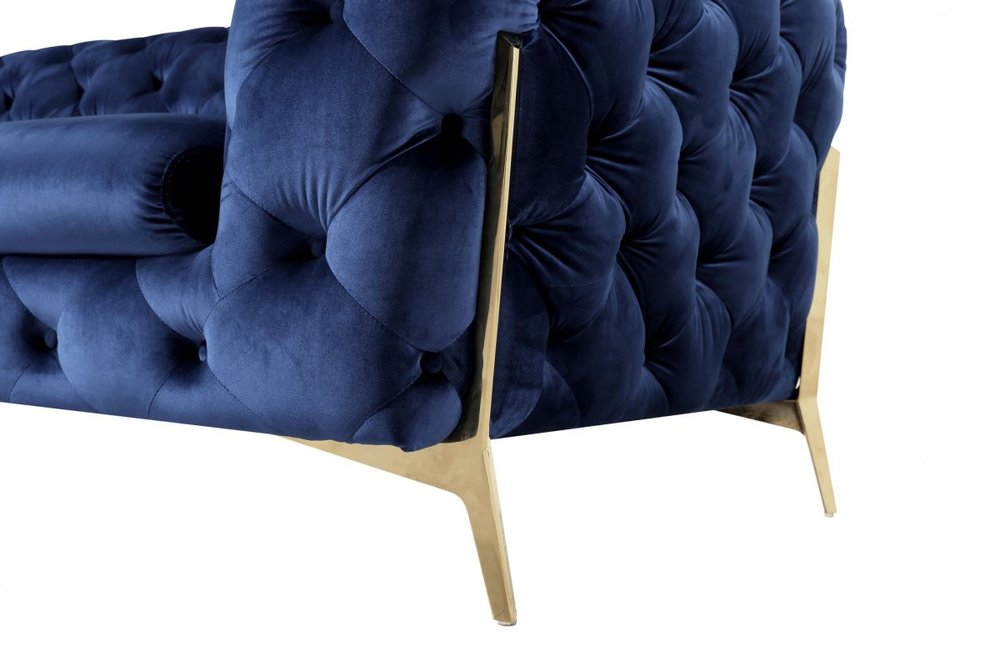 50" Blue And Gold Velvet Tufted Lounge Chair. Accent chair isolated on a plain white background, in a blue velvet finish.