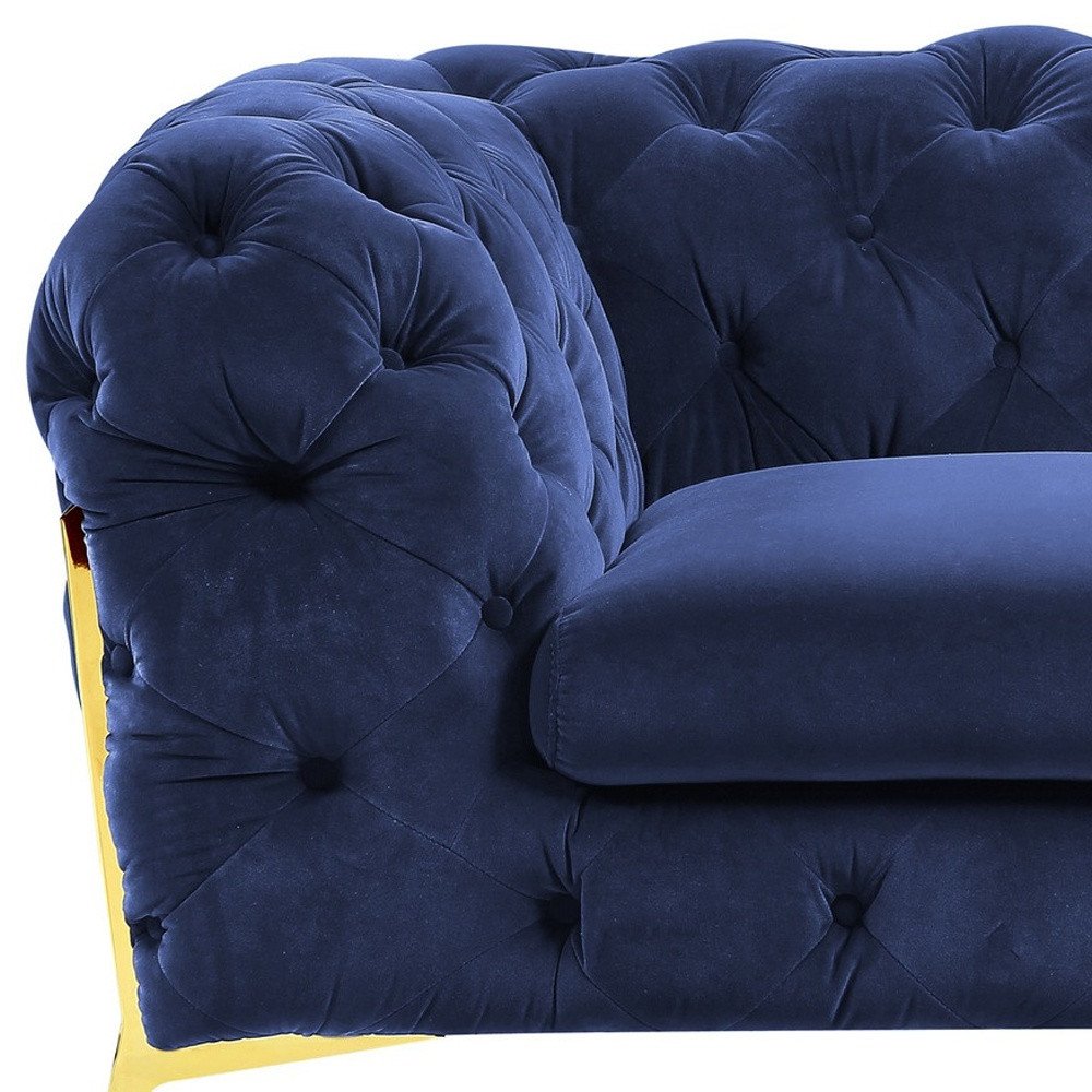 50" Blue And Gold Velvet Tufted Lounge Chair. Accent chair isolated on a plain white background, in a blue velvet finish.