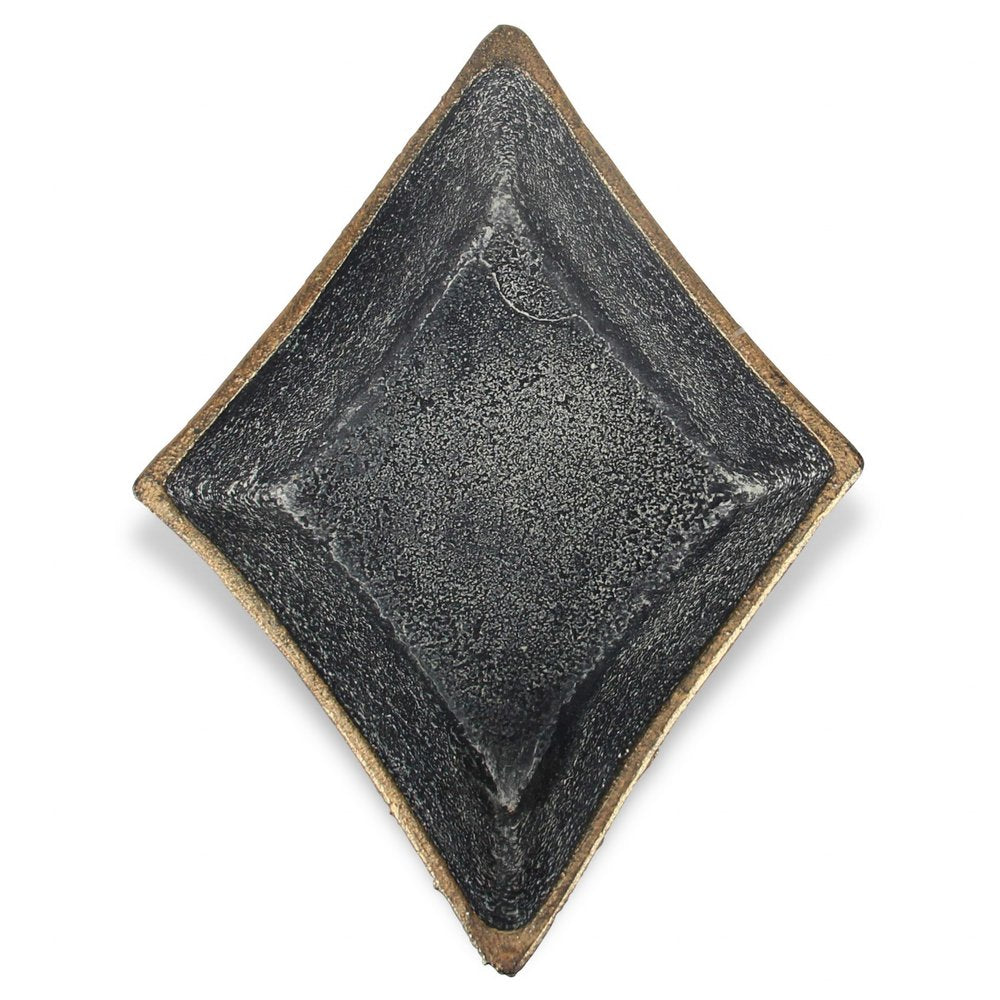 Black cast iron diamond-shaped bowl with a gold rim on a white background.