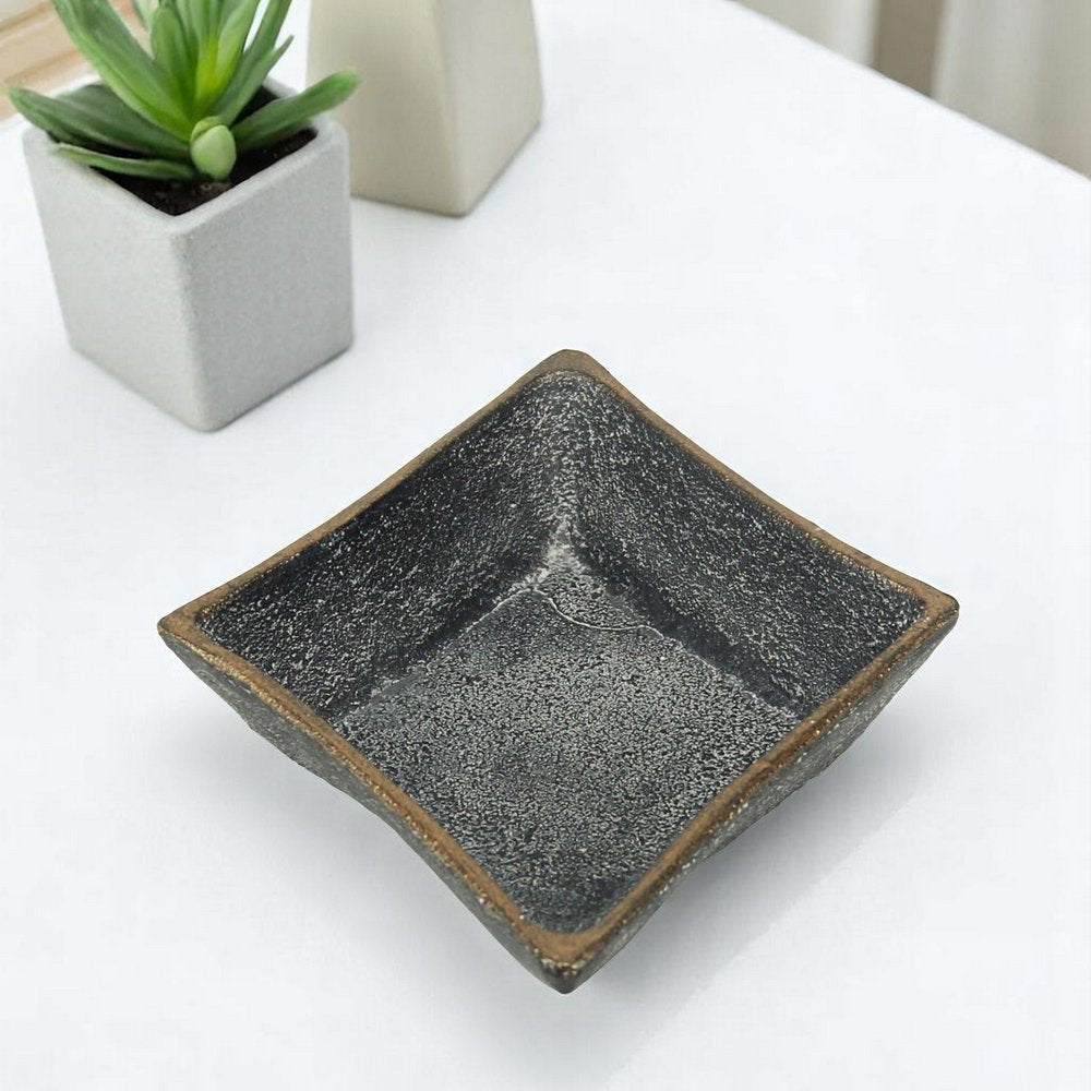 5" Black Cast Iron Diamond Square Bowl. Serving bowl isolated on a plain white background, showing a black metal surface.