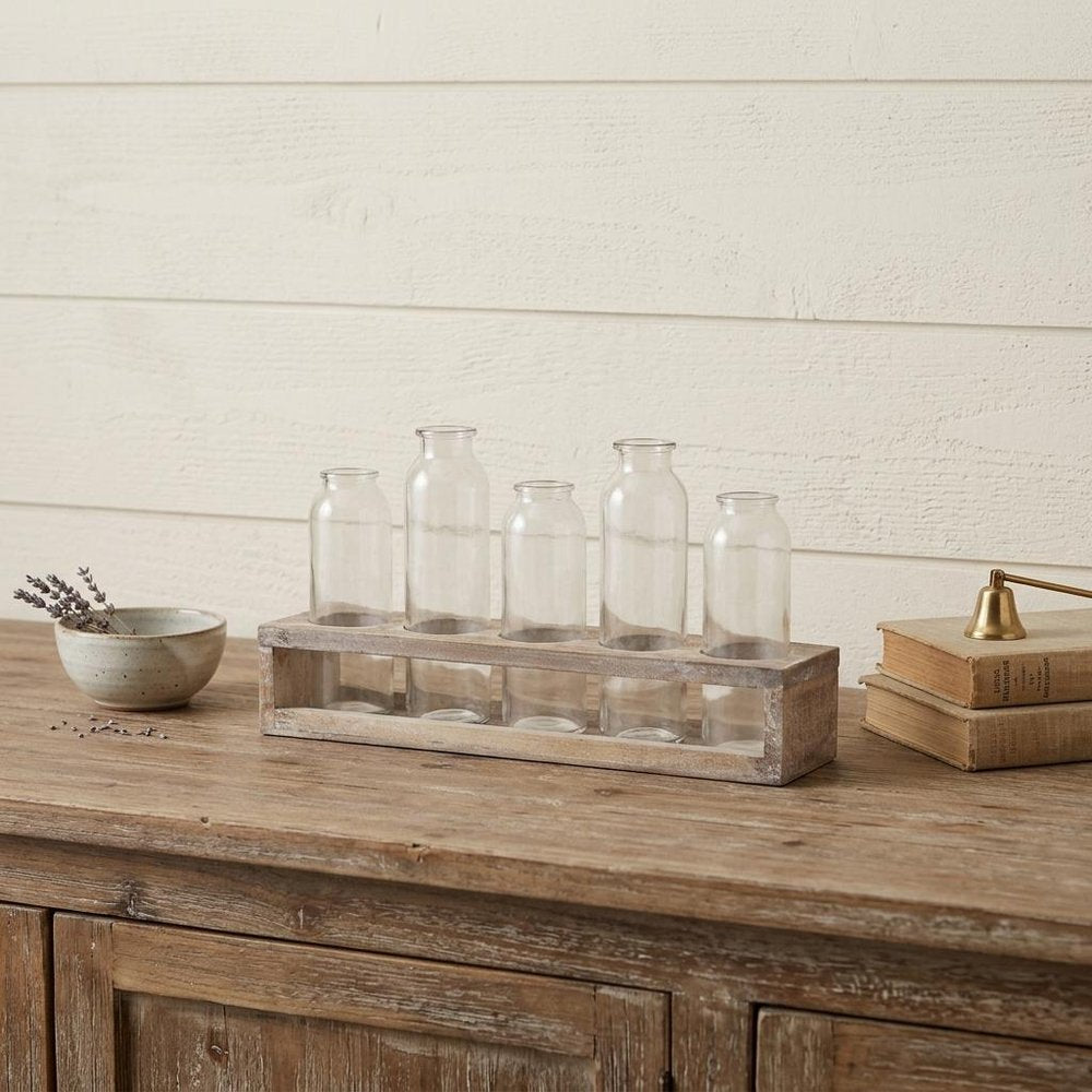 Set of Five Clear Cylinder Glass Decorative Bottles in a home interior