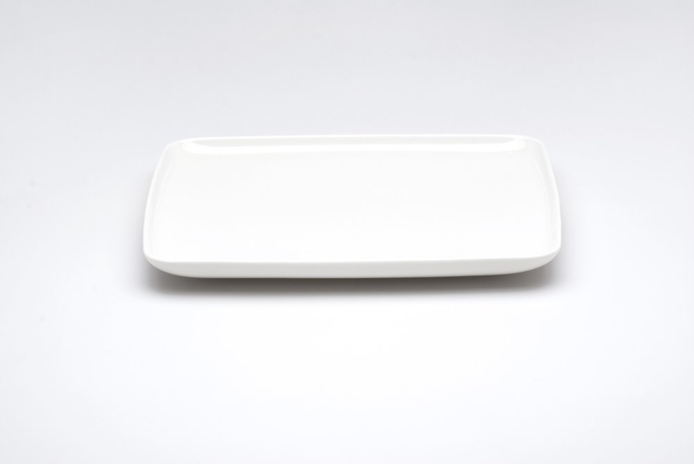 White rectangular porcelain dinner plate on a white background