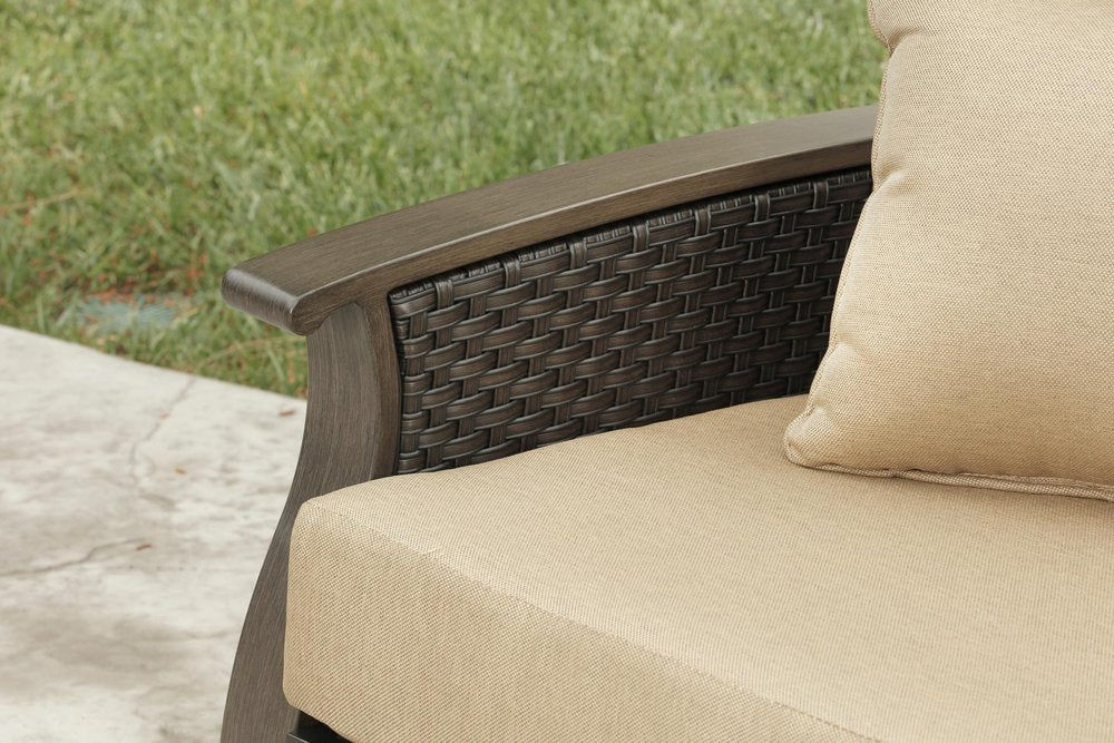 Two Piece Brown and Tan Metal Sectional Seating Group With Table in a home interior