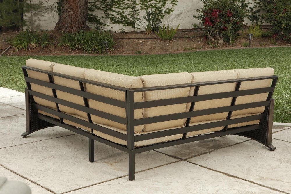 Two Piece Brown and Tan Metal Sectional Seating Group With Table in a home interior