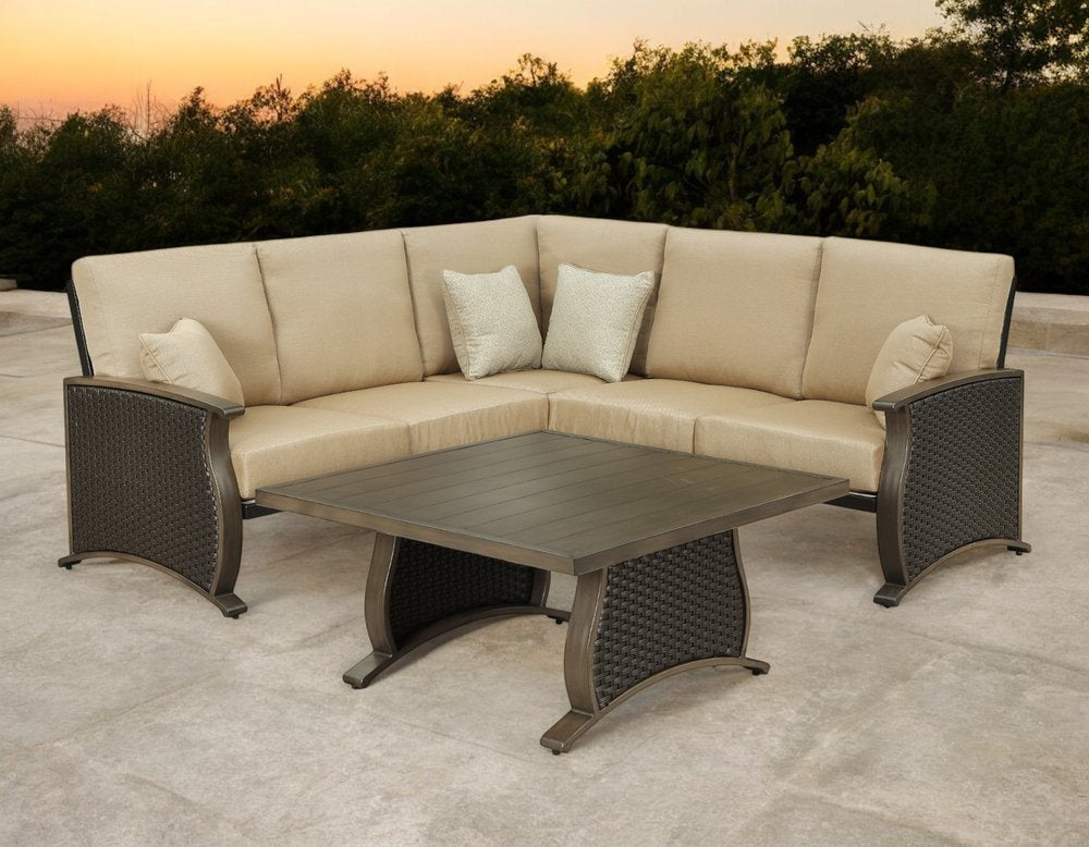 Two Piece Brown and Tan Metal Sectional Seating Group With Table in a home interior