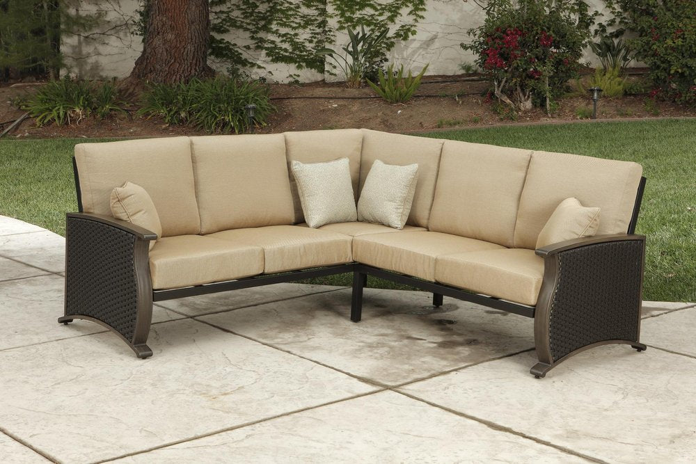 Two Piece Brown and Tan Metal Sectional Seating Group With Table in a home interior