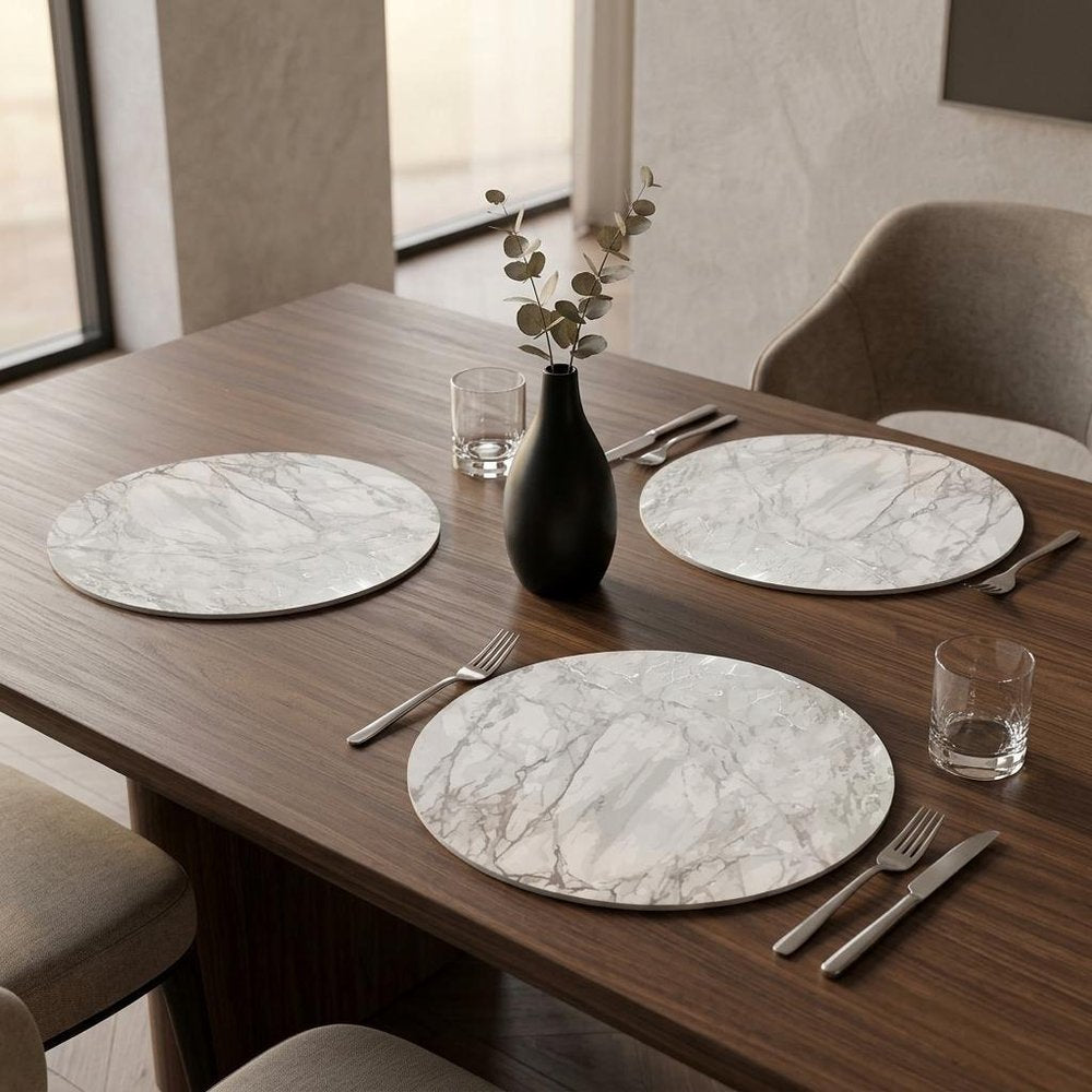 15" X 15" Silver And Gray Abstract Round Placemats styled in a furnished interior with a tan wall on a dark wood floor.