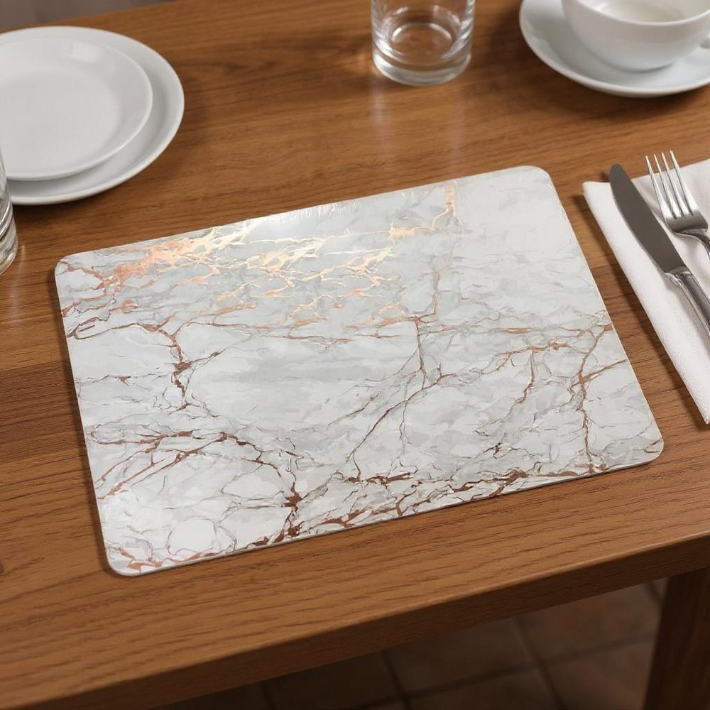 12" X 18" Gold And Silver Abstract Agglomerated cork Placemats styled in a furnished interior with a dark brown wall on a dark wood floor.