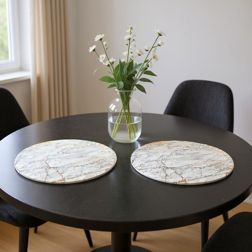 15" X 15" Gold Ivory And Gray Abstract Agglomerated cork Round Placemats styled in a furnished interior with a light gray wall on a black floor.