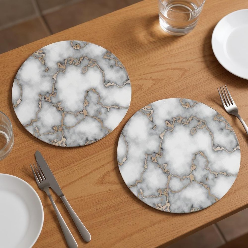 15" Set of Two Gold And Gray Abstract Round Placemats styled in a furnished interior with a dark brown wall on a dark wood floor.