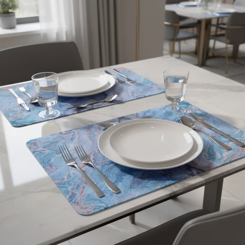 Two blue abstract faux marble cork placemats with place settings on a marble table.