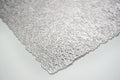 Detail view of 18" Set of Four Silver Vinyl Placemats, filling the frame with the silver linen texture.
