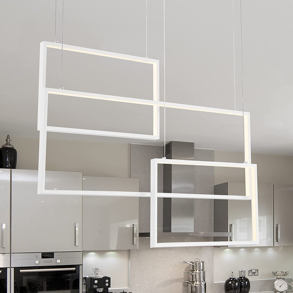 Modern white metal LED chandelier with three rectangular frames hanging in a kitchen.