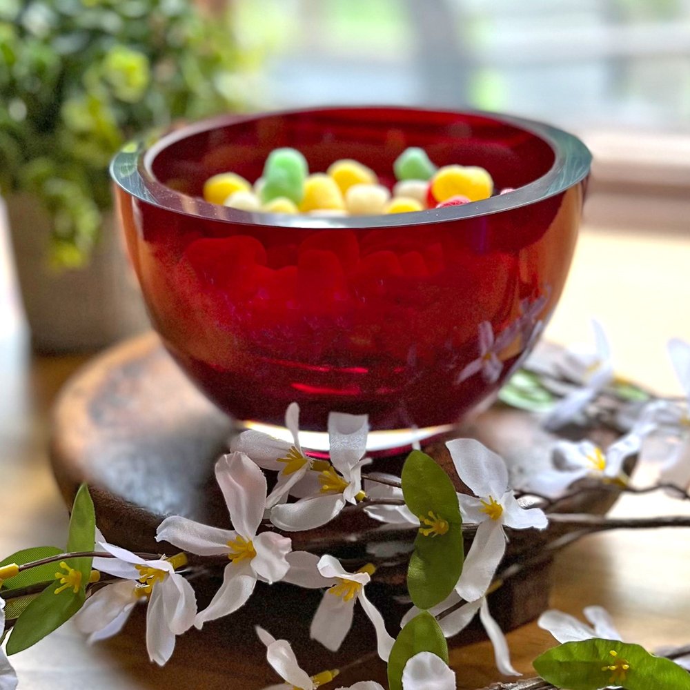 6" Red Mouth Blown Crystal Thick Walled Bowl shown outdoors on an outdoor setting with greenery.
