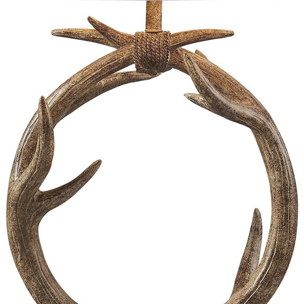 27" Brown Rustic Faux Antlers Table Lamp With White Drum Shade. Table lamp isolated on a plain white background, showing its brown color.