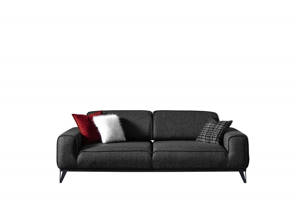 Dark gray linen sleeper sofa with red, white, and patterned toss pillows on silver legs against a white background.