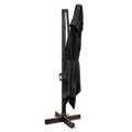 Black polyester cantilever patio umbrella folded and tied to a dark brown pole with a cross-shaped base on a white background.