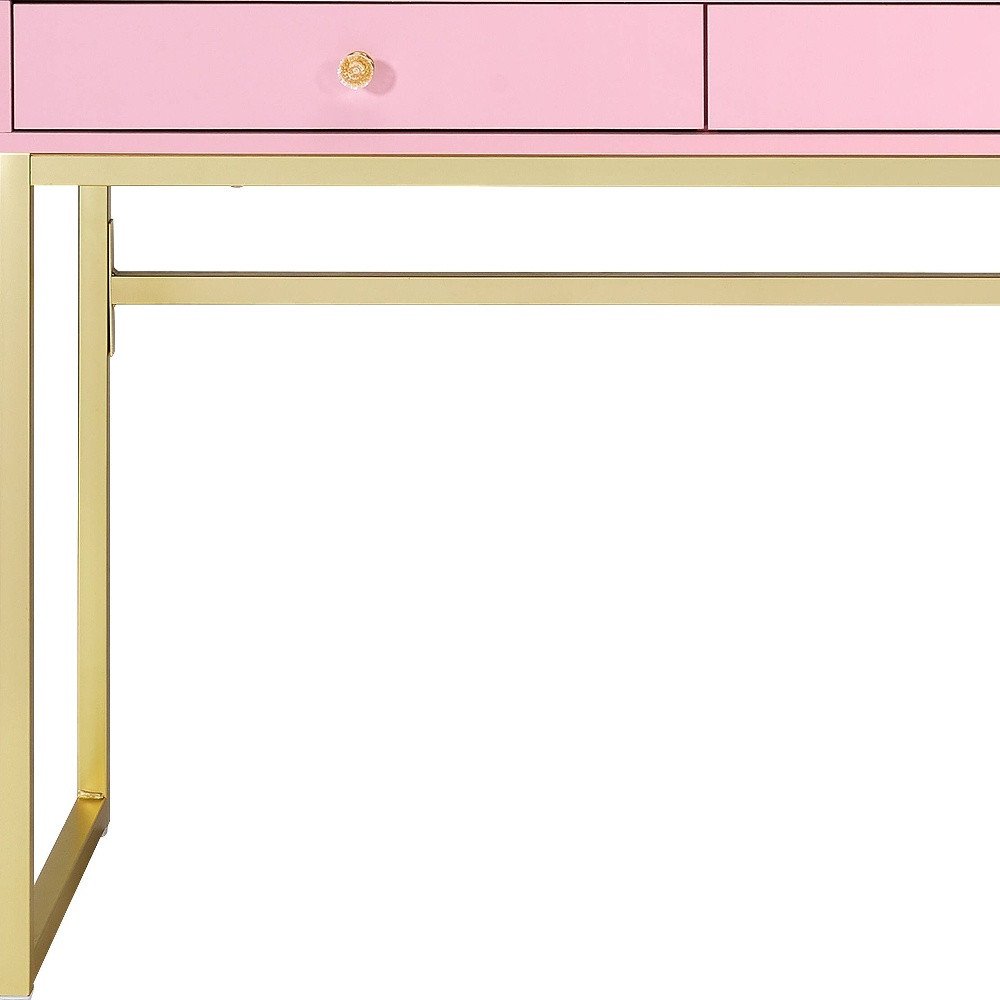 42" Gold And Pink Wood Vanity Table With Mirror And Two Drawers. Vanity table isolated on a plain white background, showing a pink wood surface.
