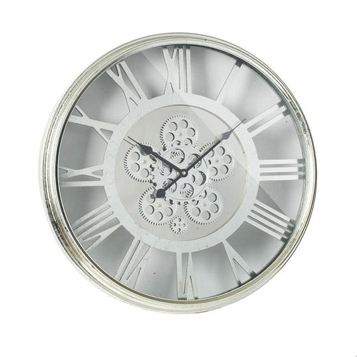 Silver metal and glass analog wall clock with exposed gears and Roman numerals on a white background.