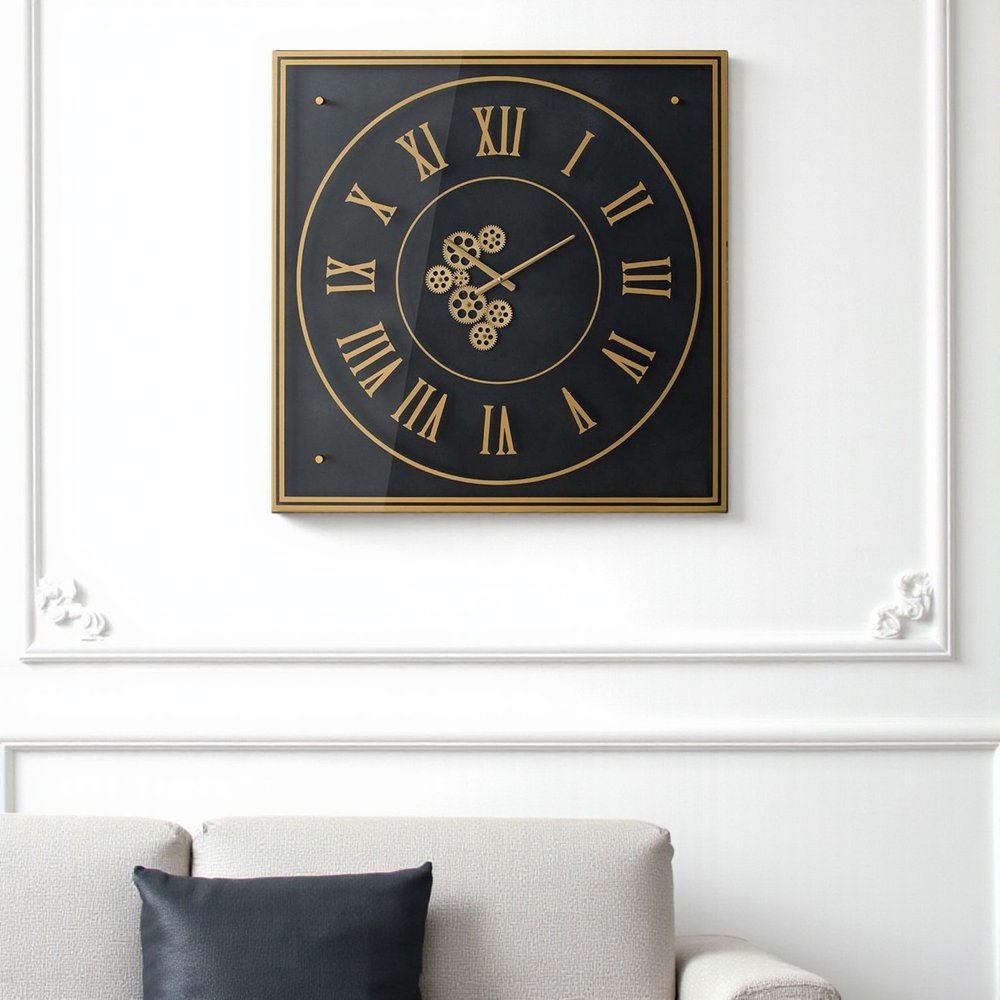 35" Black And Gold Glass And Metal Exposed Gear Square Wall Clock. Wall clock isolated on a plain white background, in a black glass finish.