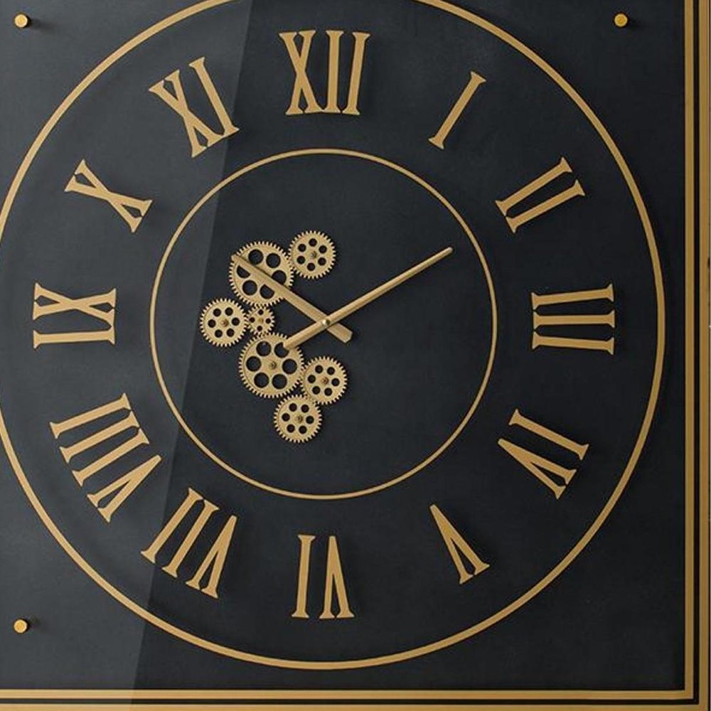 35" Black And Gold Glass And Metal Exposed Gear Square Wall Clock photographed against a dark studio background in gold.