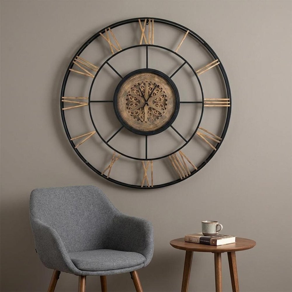 56" Circle Copper Metal and Glass Analog Exposed Gear Wall Clock styled in a furnished interior with a tan wall on a dark wood floor in tan glass.