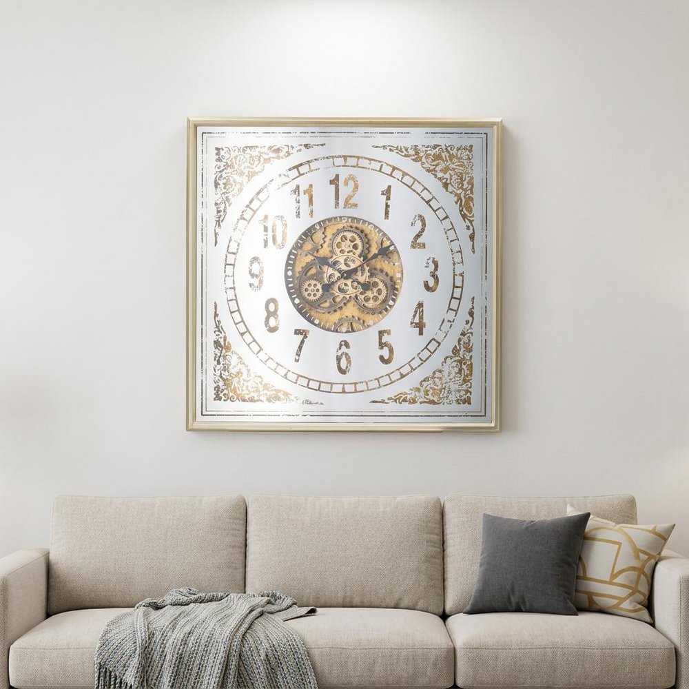 32" Square Gold and Silver Wood and Mirror Analog Exposed Gear Wall Clock styled in a furnished interior with an off-white wall on a wood floor.