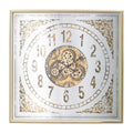 Square analog wall clock with gold and silver exposed gears, Roman numerals, and ornate corner details on a mirrored face.