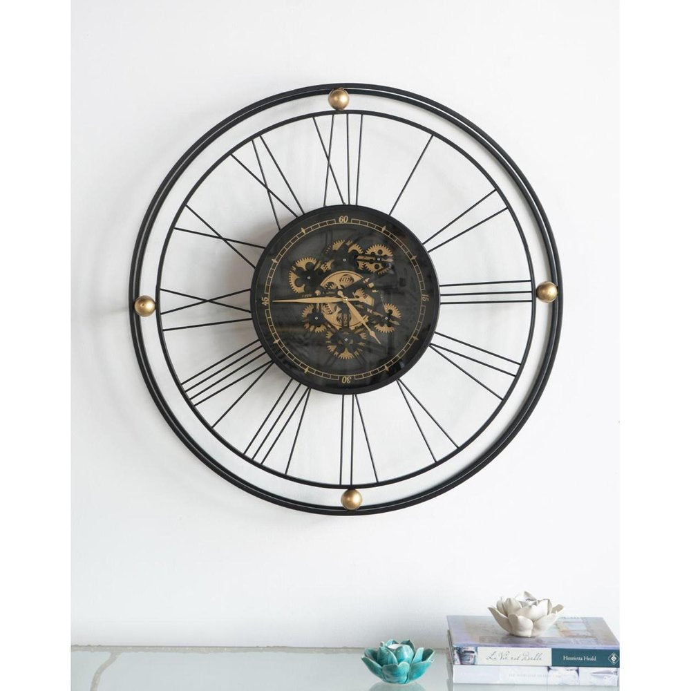 32" Circle Black and Gold Metal and Glass Analog Exposed Gear Wall Clock. Wall clock isolated on a plain white background, showing a black glass surface.
