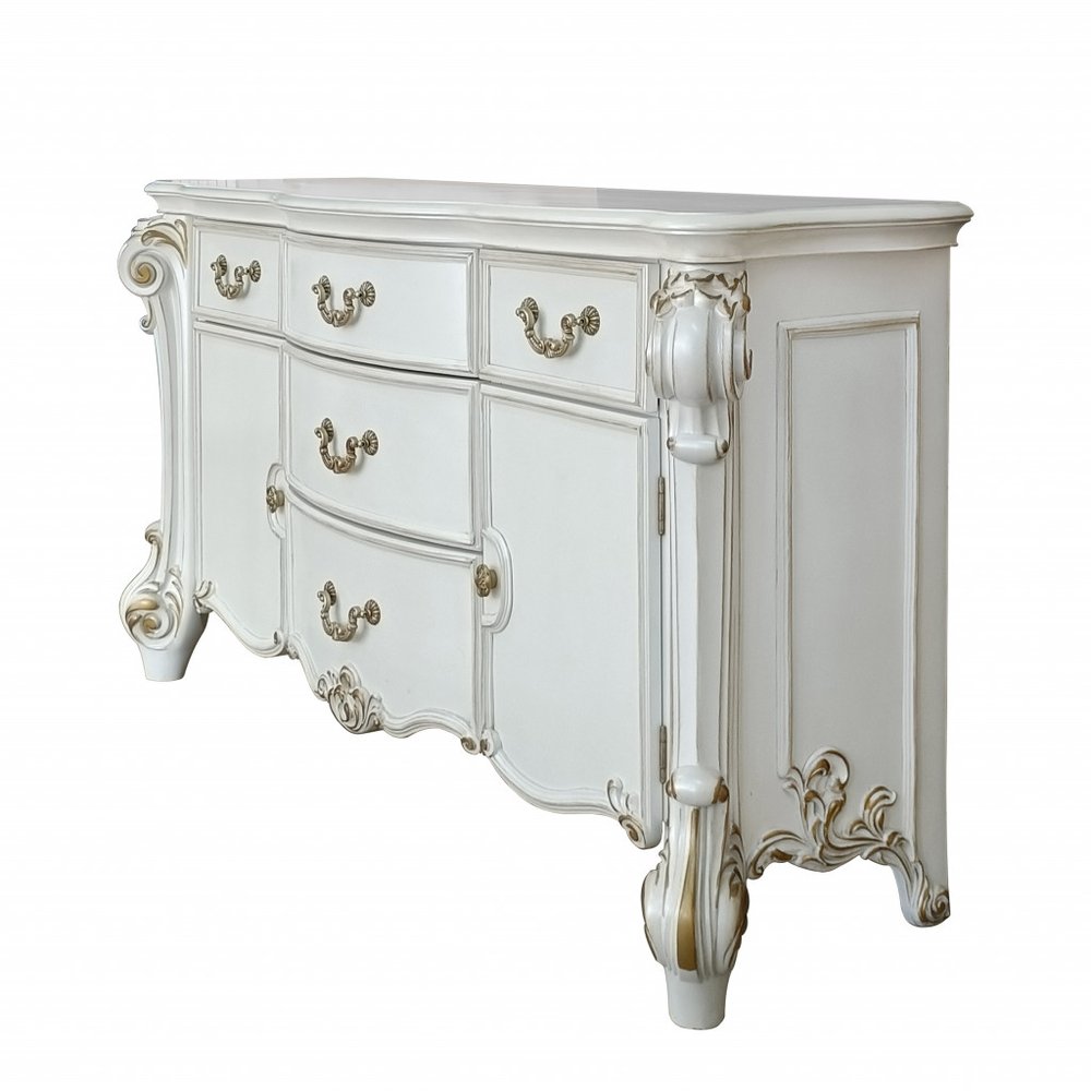 White five-drawer dresser with ornate gold accents and carved legs on a white background.