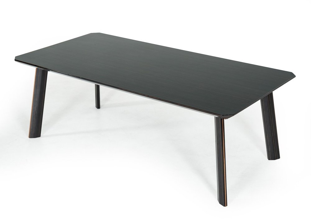 Rectangular ebony dining table with angled legs on a white background.