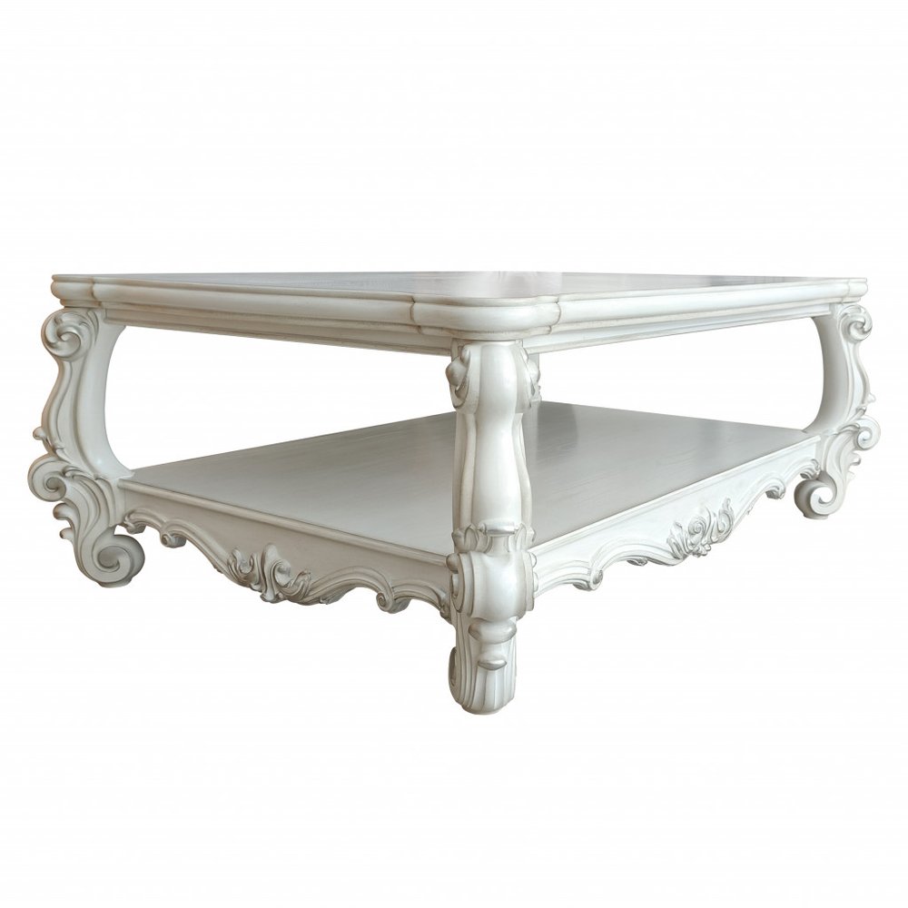 57" Antiqued White Wood Coffee Table With Shelf. Coffee table isolated on a plain white background, showing a white wood surface.