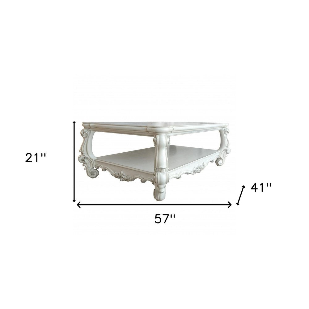 57" Antiqued White Wood Coffee Table With Shelf. Coffee table isolated on a plain white background, in a white wood finish.