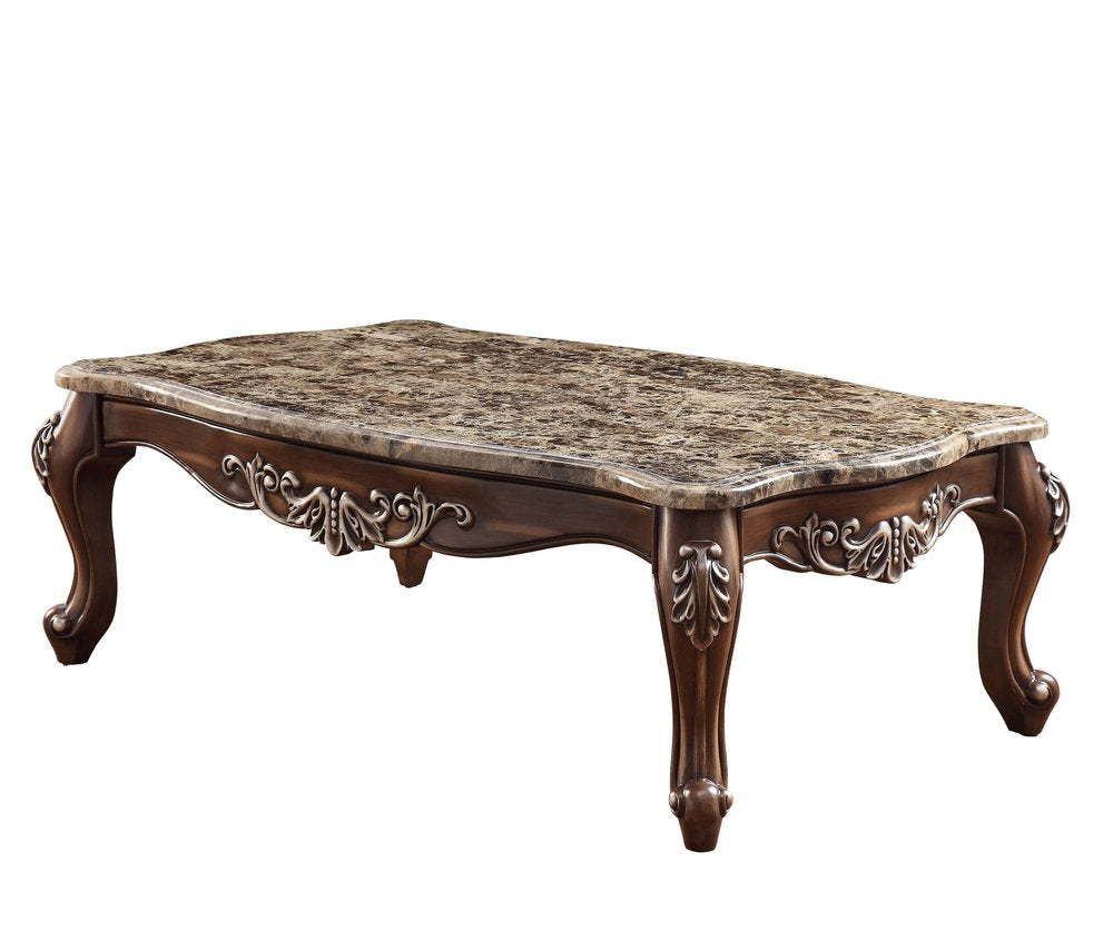 Rectangular coffee table with a faux marble top and dark wood base with ornate carvings on a white background.