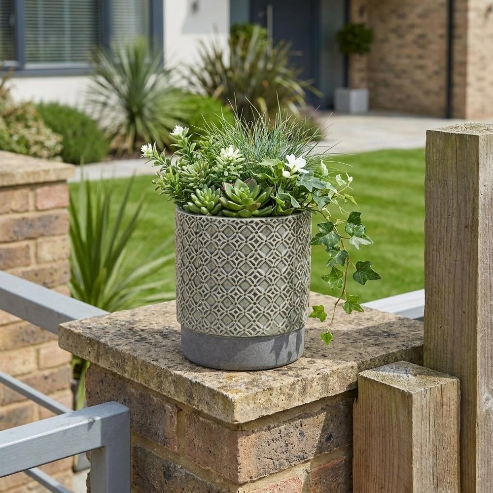 6" Gray Geometric Ceramic Indoor Outdoor Round Pot Planter shown outdoors on a patio with greenery.