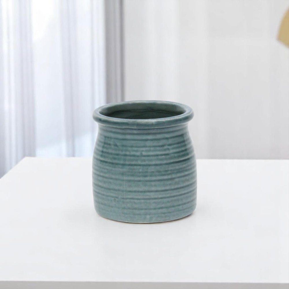 Green Ceramic 12 Ounce Striped Round Distressed Pot Planter on a white background
